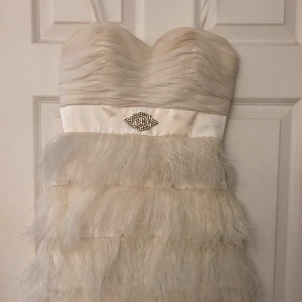 Feather like cream dress!  Very teeny!